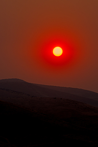 sun rising over Boise foothills in smoke from wildfires